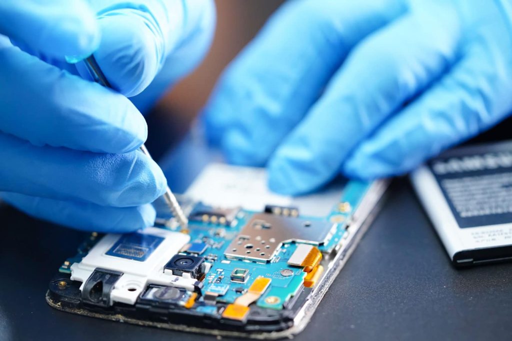 Repair technician servicing a cell phone