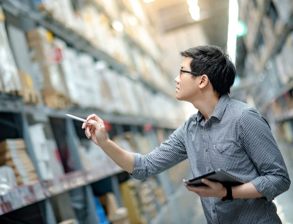 Man managing inventory on a tablet with ServiceCentral solutions