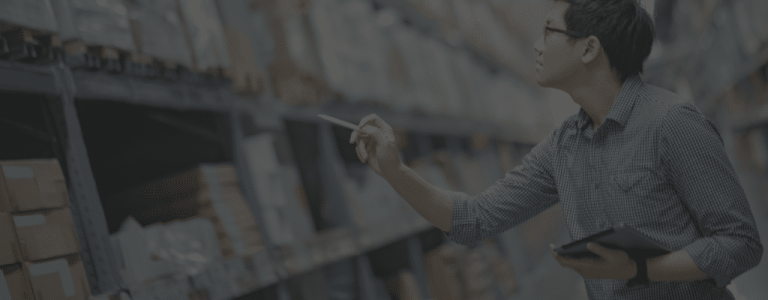 Employee taking inventory in a warehouse