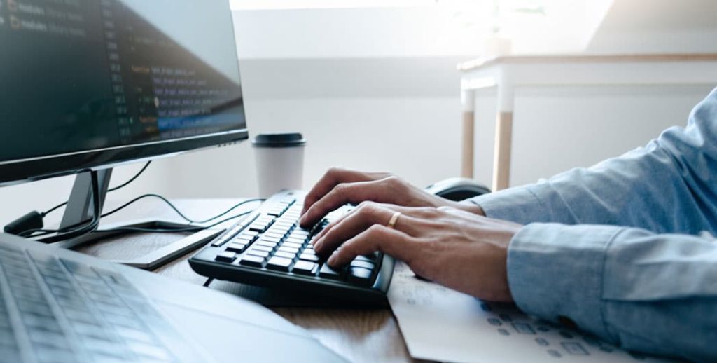 Manager on a desktop looking through ServiceCentral's network management solution