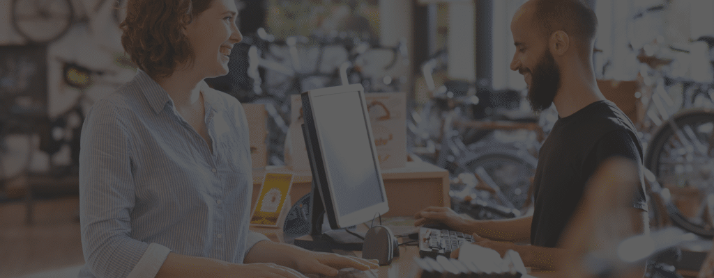 Employee checking a customer out with ServiceCentral Technologies, Inc. solutions