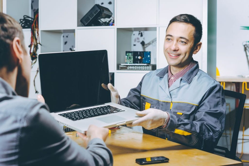 repair tech explaining warranty policy to a customer