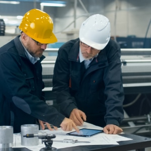 Manufacturing workers using a ServiceCentral product on a tablet