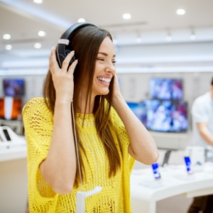 Woman in a retail sampling headphones