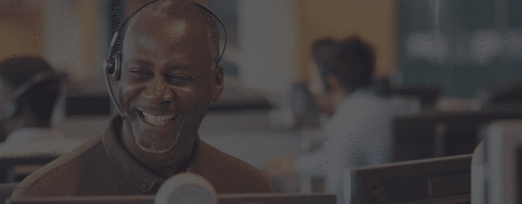 Happy customer service representative talking on hands free headset