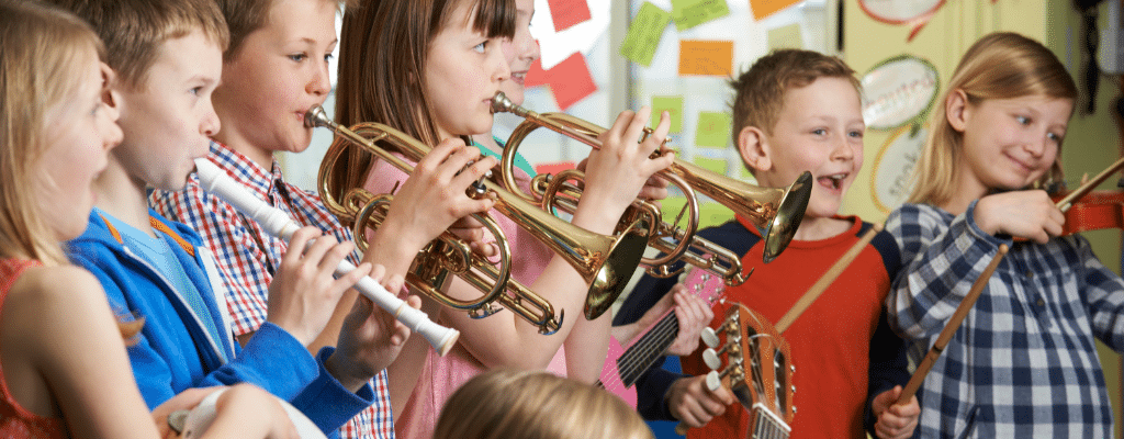 Children happily playing musical instruments