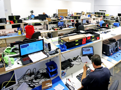 Technicians working to repair small electronics.