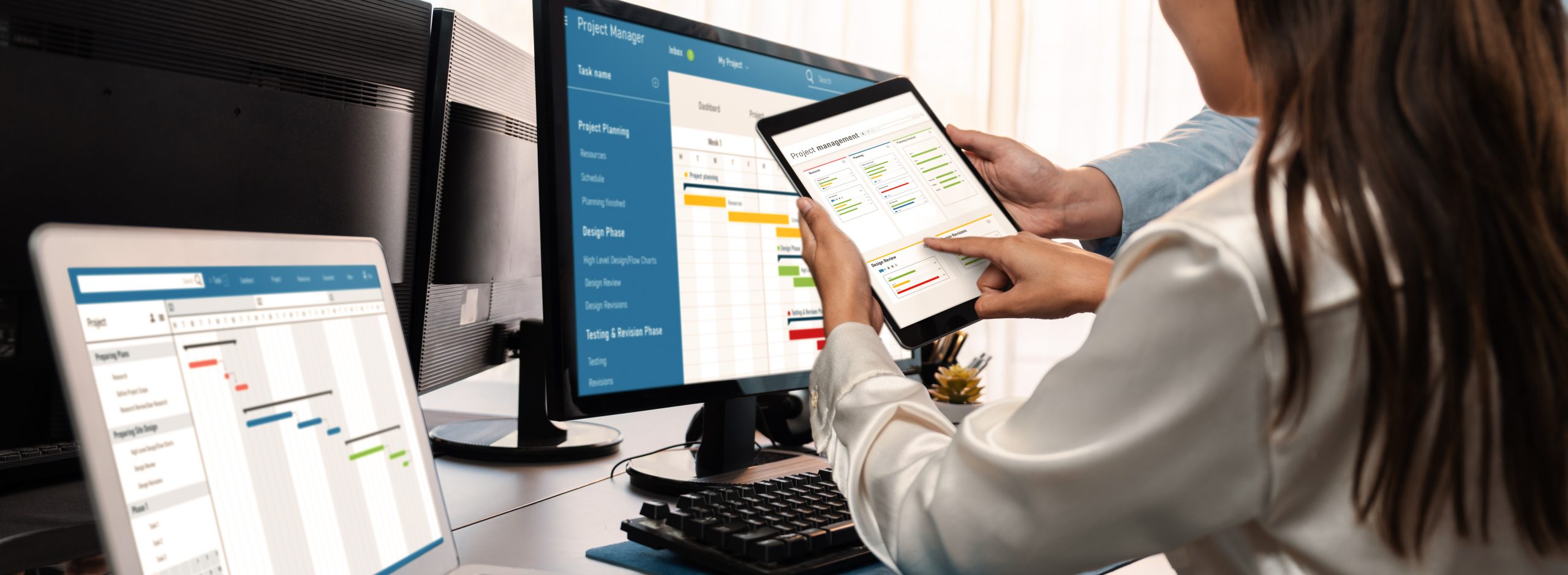 A team of people gathered around a computer, viewing workflow management software designed to streamline tasks and enhance productivity.
